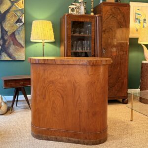 Ancien comptoir de boutique années 30 en placage de chêne, forme ovale.